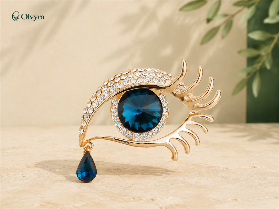 Broche œil sertie Olvyra — Doré et bleu.
