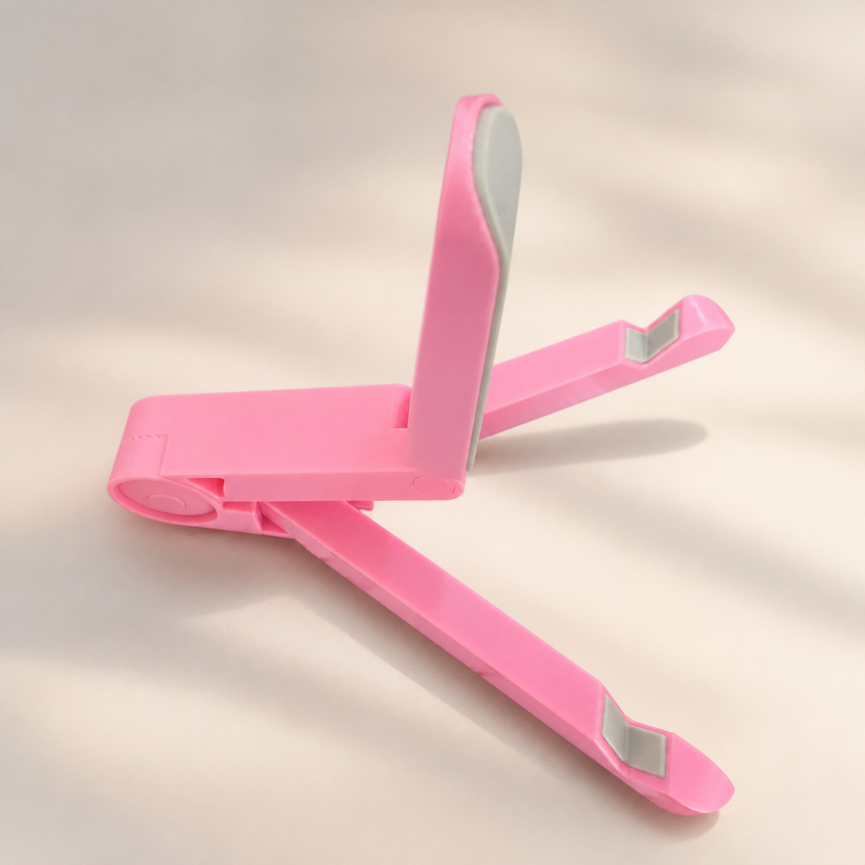 Support pliable rose pour téléphone et tablette — Pink foldable phone and tablet stand